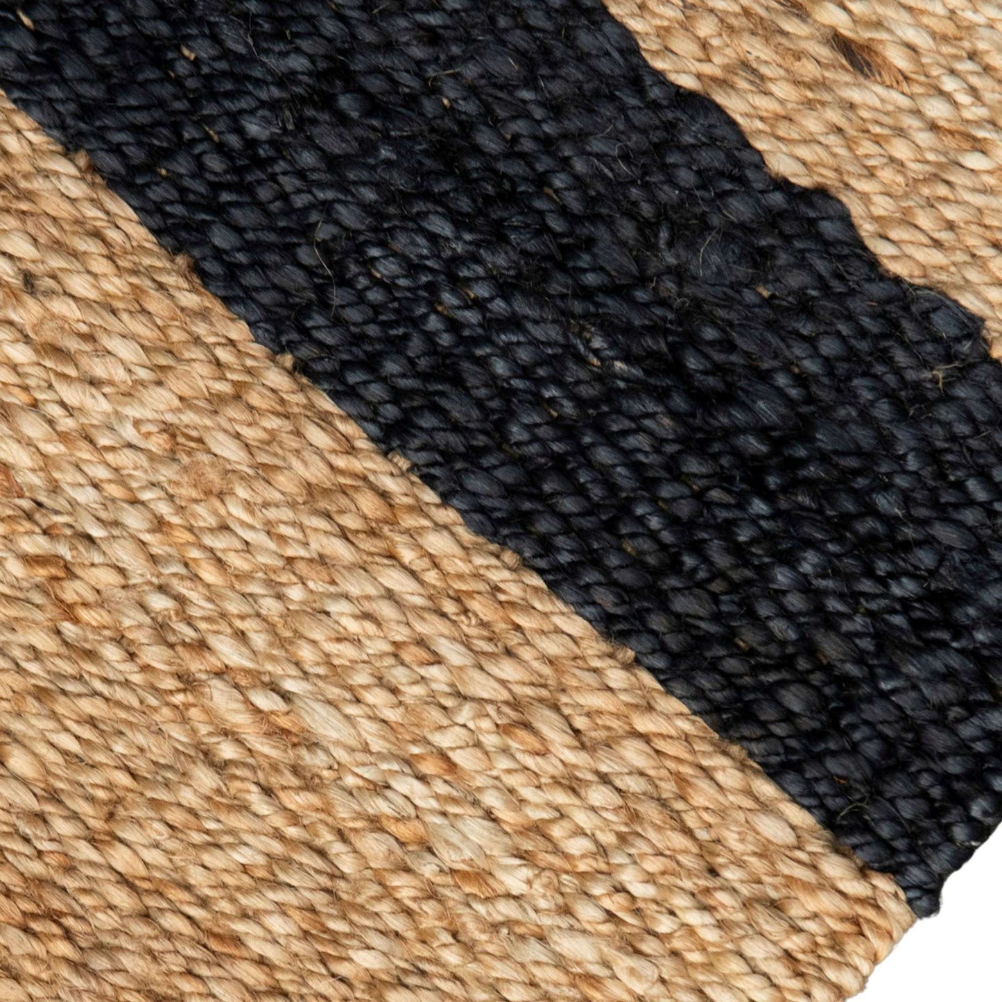 Close-up of handcrafted baxter stripe jute flatweave rug with graphite and beige stripes and white background.