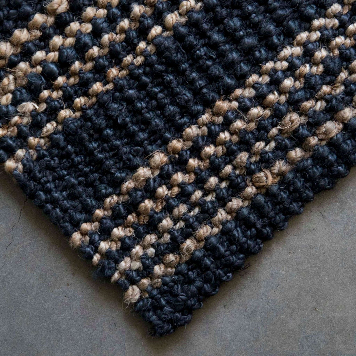 Close-up of the graphite Jones woven boucle texture and natural stripe.