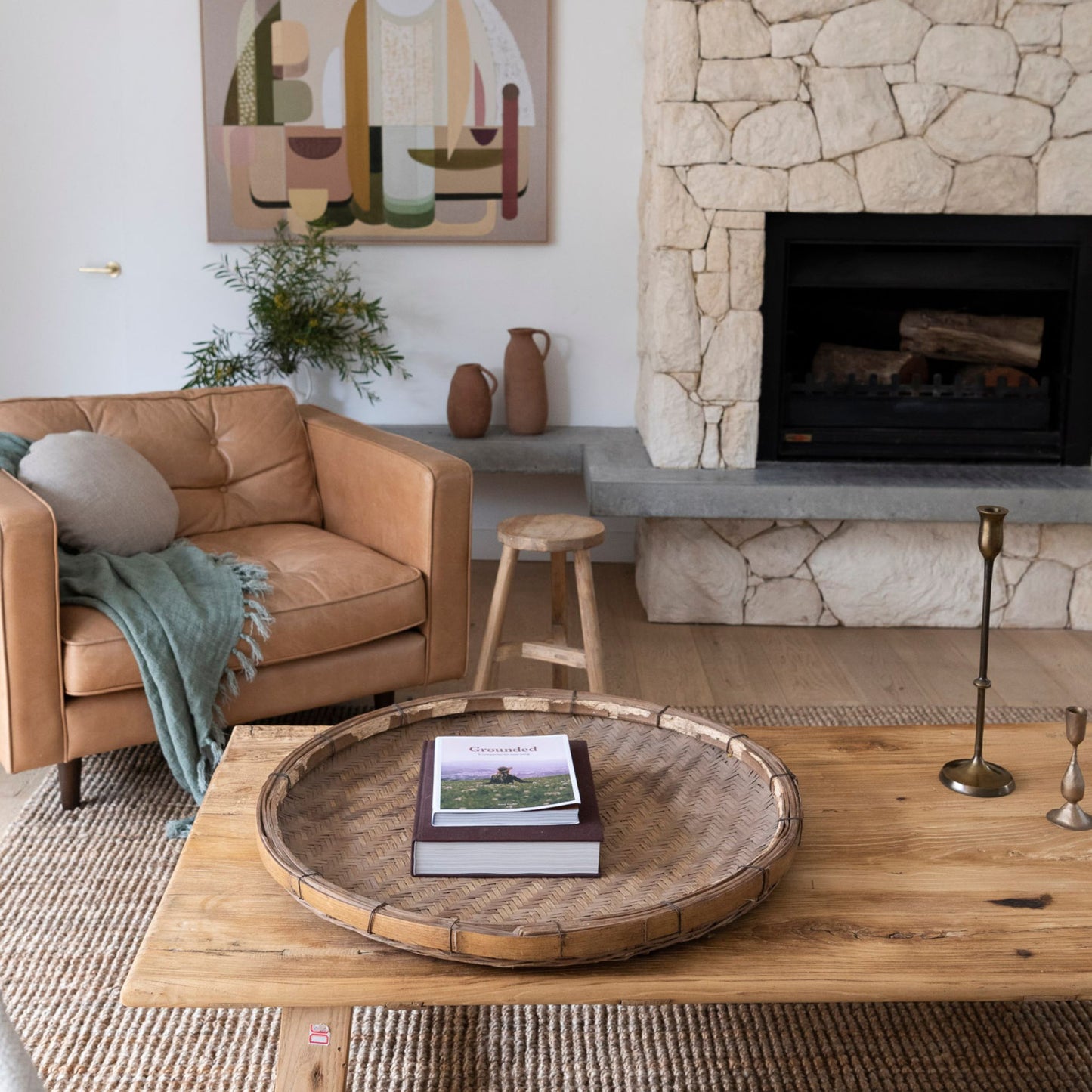 Handcrafted natural bouclé jute area rug in contemporary living room with fireplace.