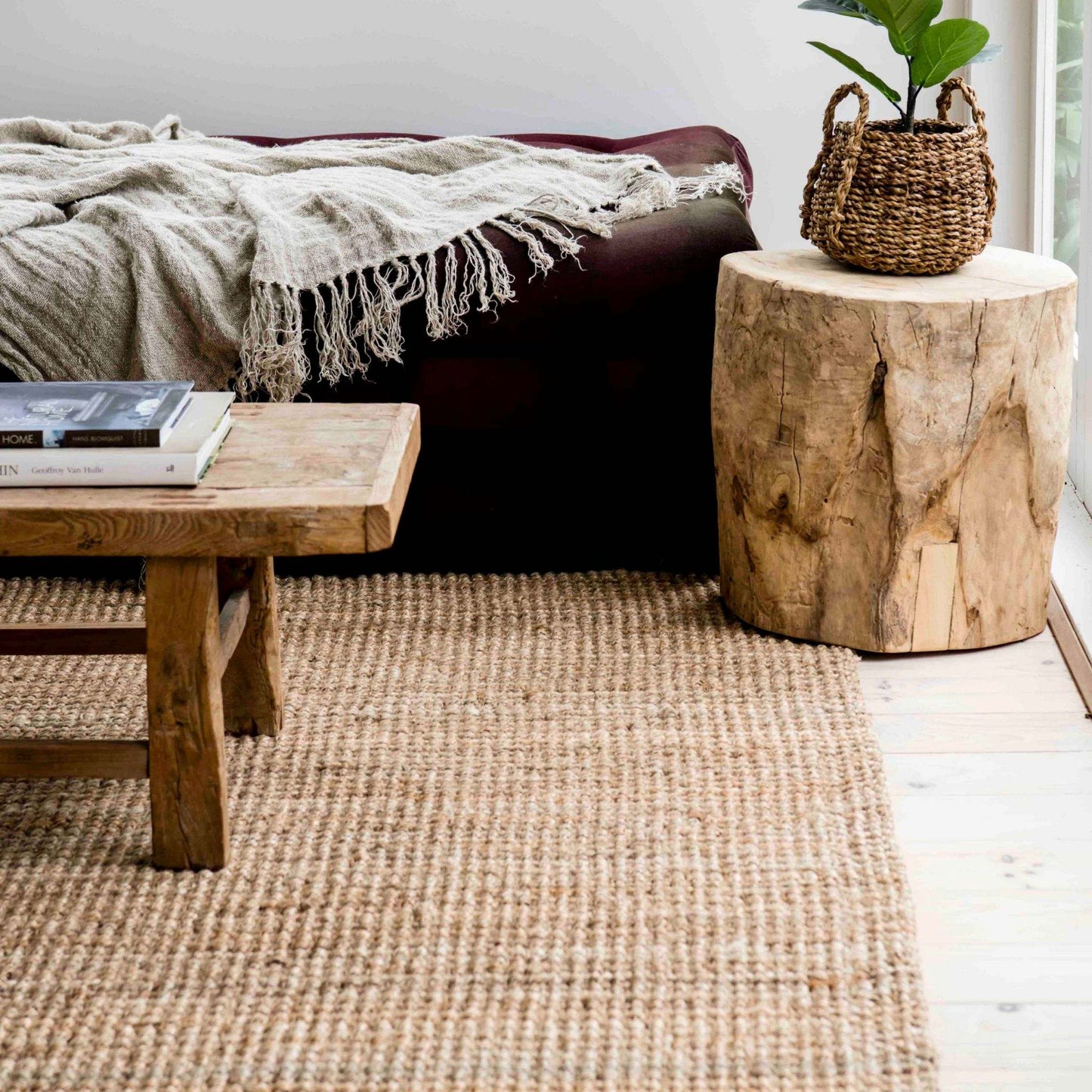 Handcrafted natural bouclé jute small area rug in a nook with a window view.