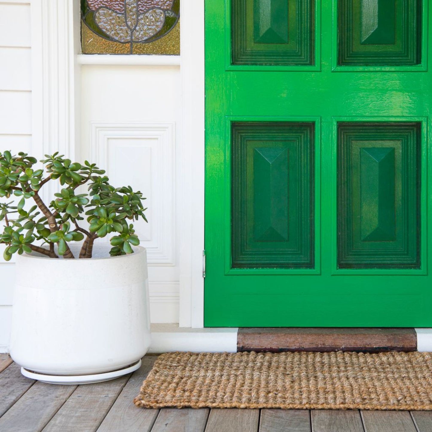Handcrafted natural bouclé jute small rug on a undercover porch.