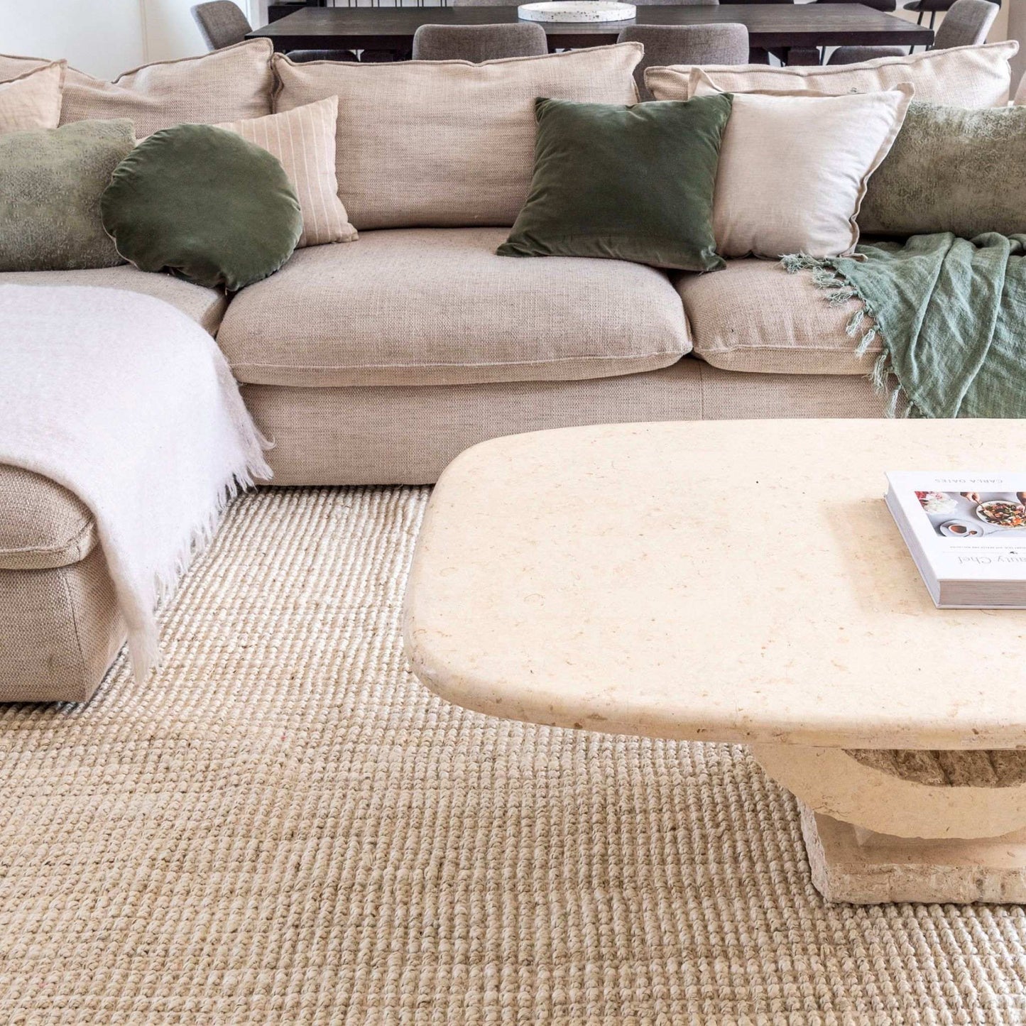 Vincent, whitewashed, chunky jute bouclé large area rug in a cozy living room with neutral furnishings.