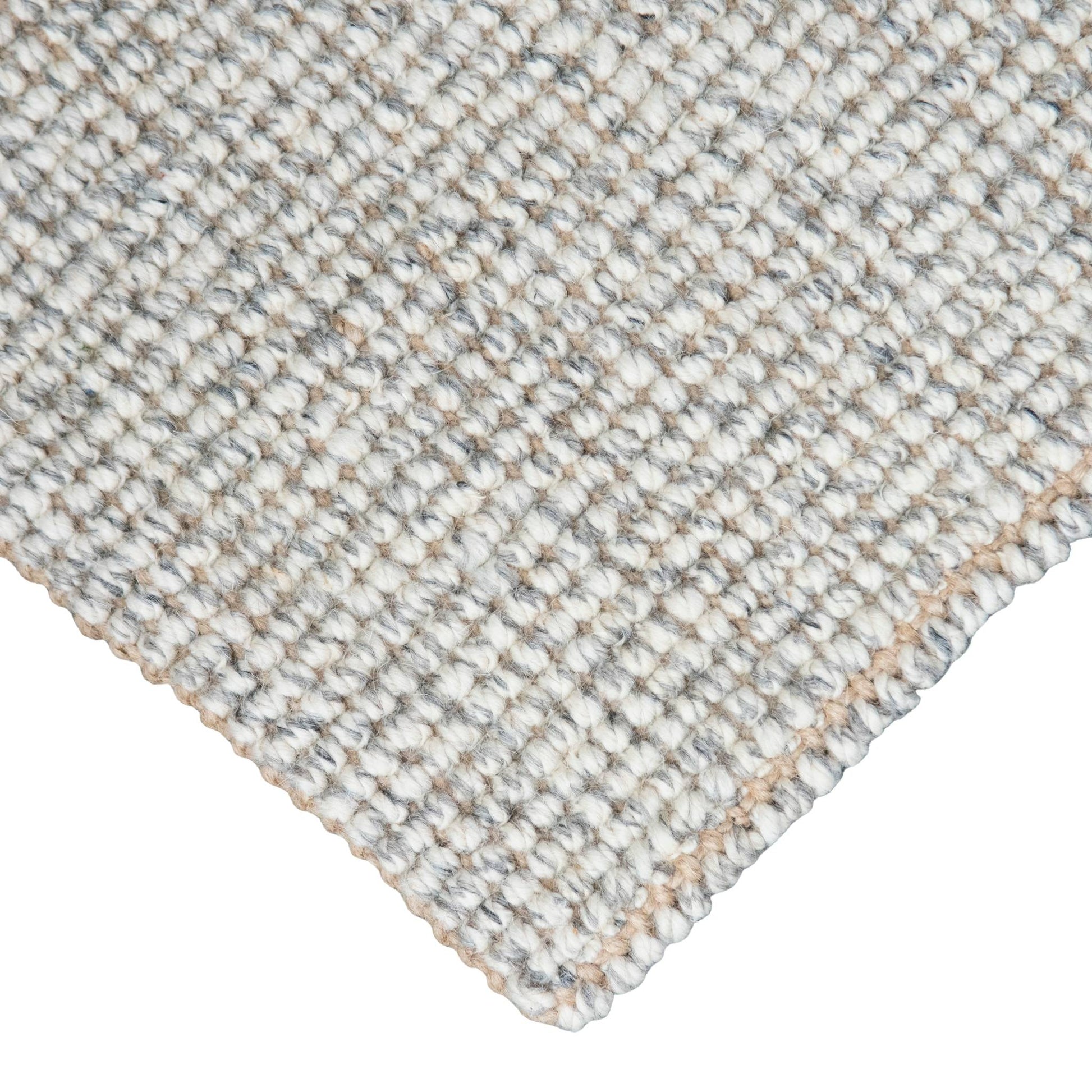 Close-up of Carter handcrafted  grey white heathered wool and jute bouclé rug.