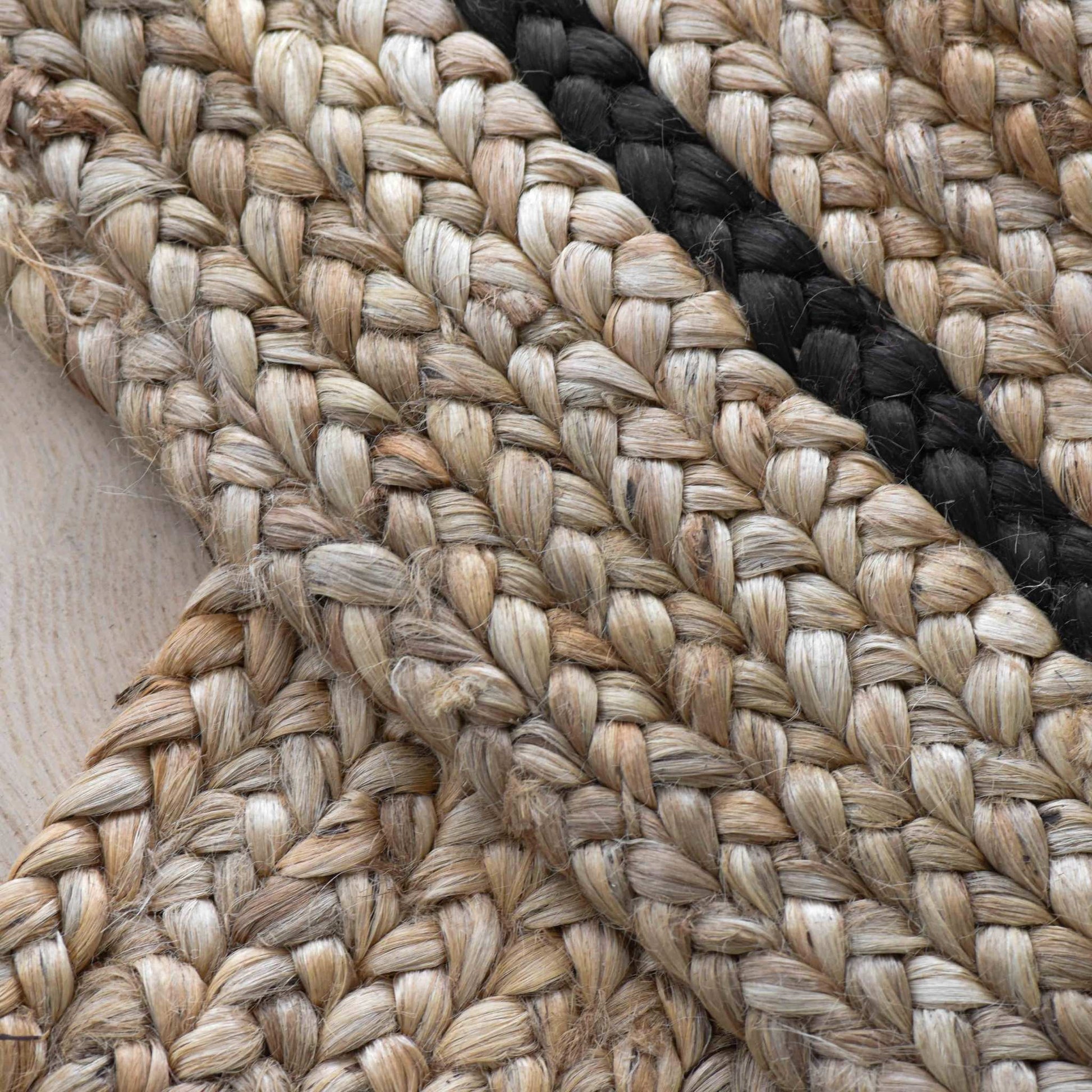 Close-up of braided natural jute fibers material with graphite accent.