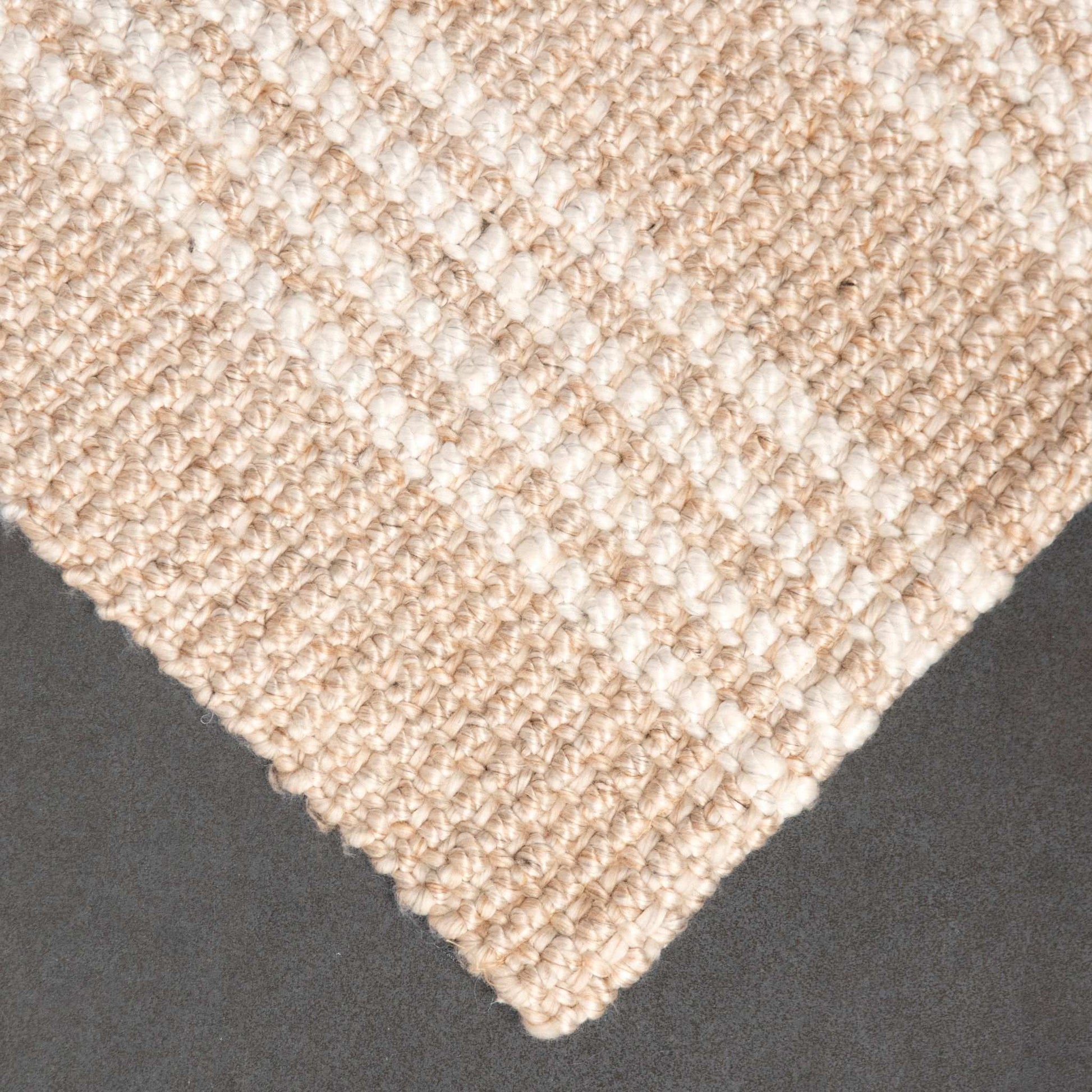 Close-up of Franklin flatweave rug, with natural and white stripes, made from 100% recycled PET.