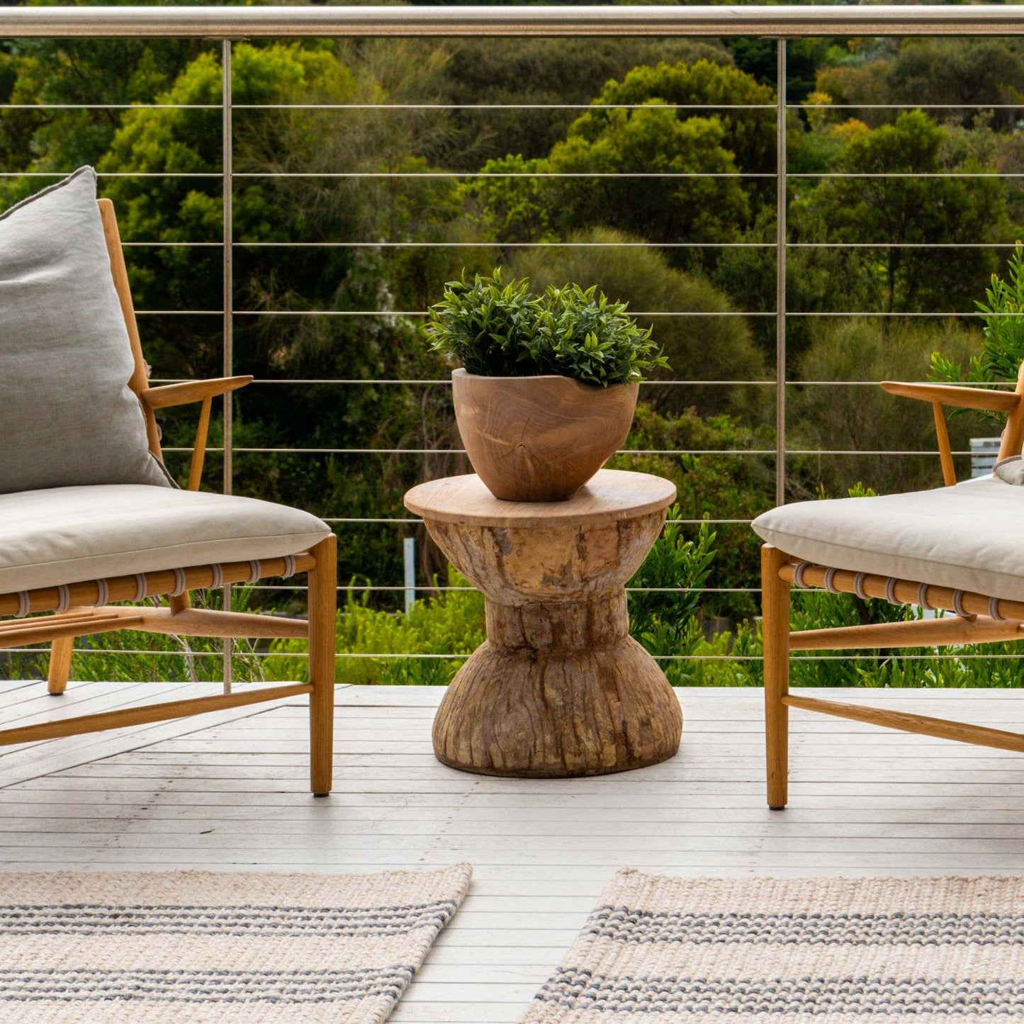 Macintosh flatweave rugs, with natural and slate grey stripes made from 100% recycled PET sitting on timber coastal deck. 