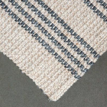 Close-up of Macintosh flatweave rug, with natural and slate grey stripes made from 100% recycled PET with slate background.