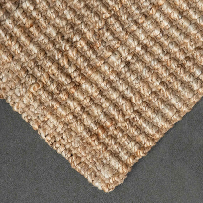 Close-up of Handcrafted natural bouclé weave jute texture with slate background.