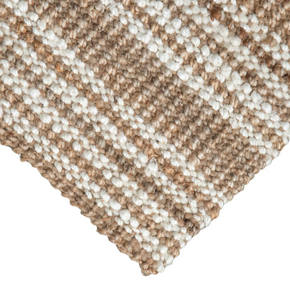 Close up of Handcrafted Osbourne natural chunky jute bouclé rug with white stripes and white background.