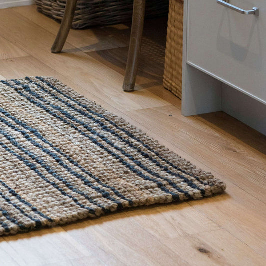 Small Smith jute natural bouclé rug with graphite stripes on light timber floors in an office near a desk.  