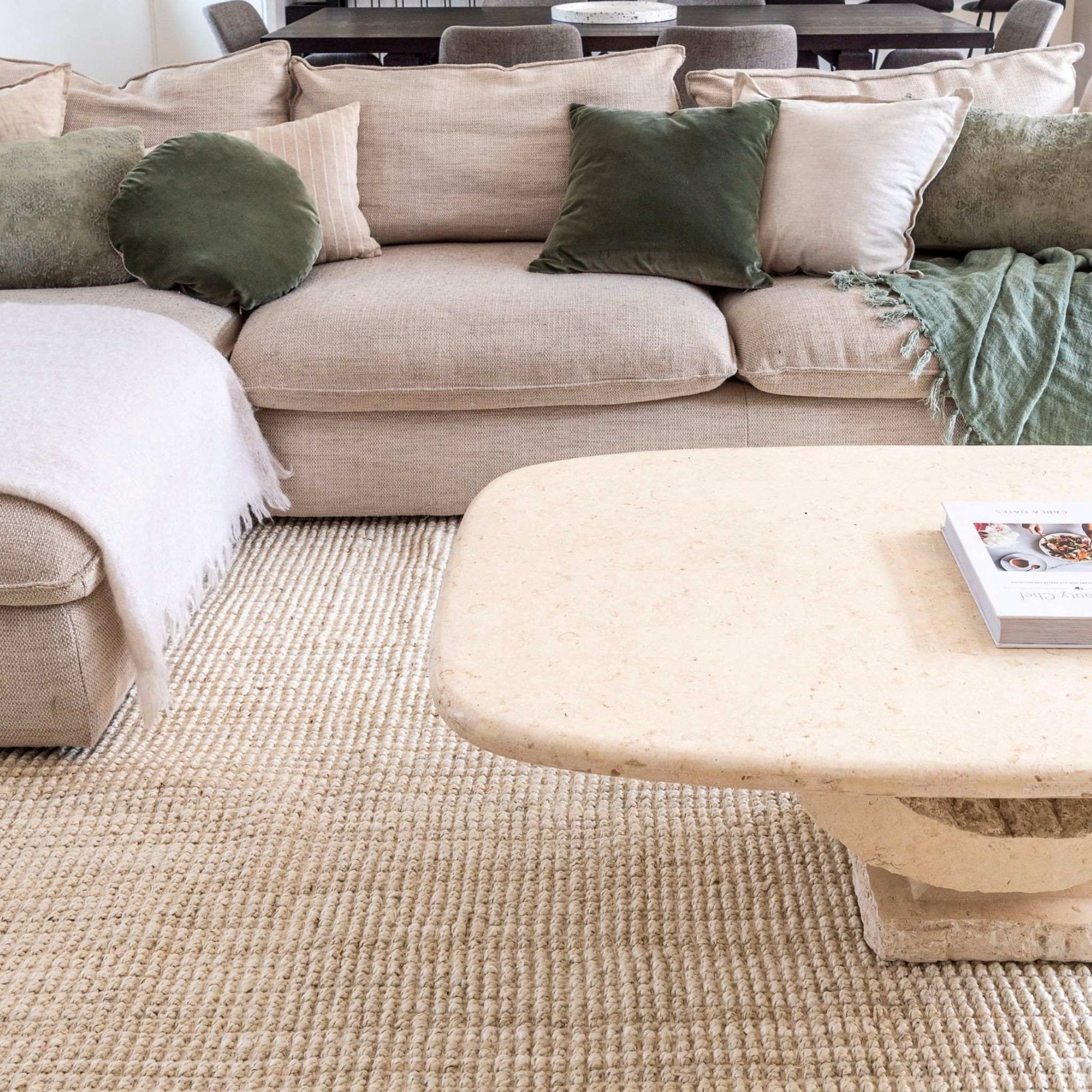 Vincent, whitewashed, chunky jute bouclé large area rug in a cozy living room with neutral furnishings. 