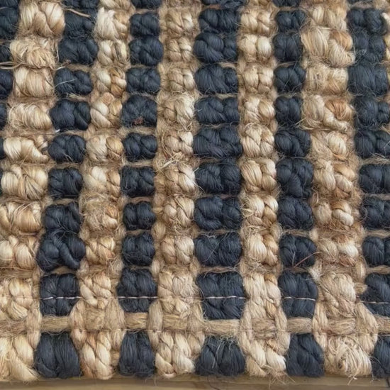 Close-up video of the woven bouclé  texture and white stripes on the Caravan rug.