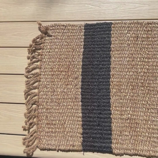 Close up video of the handcrafted Baxter stripe jute flatweave rug