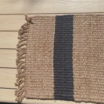 Close up video of the handcrafted Baxter stripe jute flatweave rug