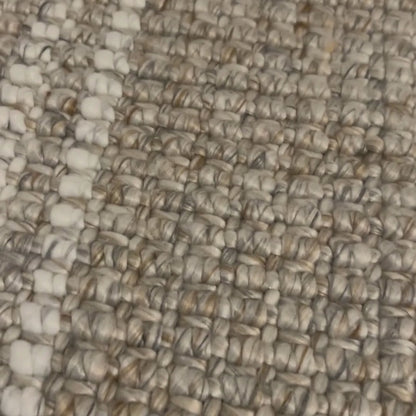 Close-up video Franklin flatweave rug, with natural and white stripes, made from 100% recycled PET with white background.