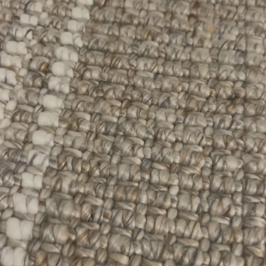 Close-up video Franklin flatweave rug, with natural and white stripes, made from 100% recycled PET with white background.