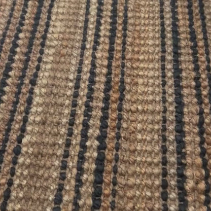 Close-up video of the woven, chunky bouclé texture and graphite stripes on the Smith style jute rug.